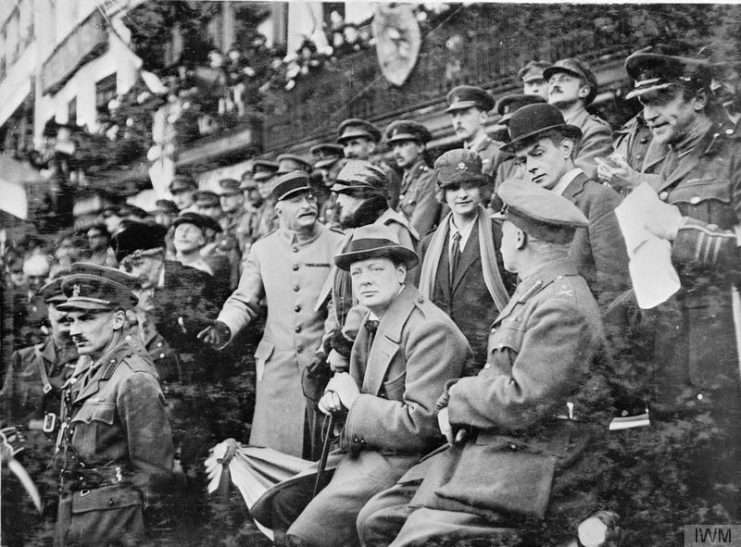 The Minister of Munitions, Winston Churchill, watching the march past of the 47th (2nd London) Division in the Grande Place, Lille. In front of him is the Chief of Staff of the 47th Division, Lieutenant-Colonel Bernard Montgomery.