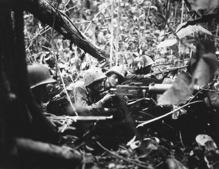 Marines push back a Japanese counterattack with a Browning Machine Gun M1917 during the Pacific War.