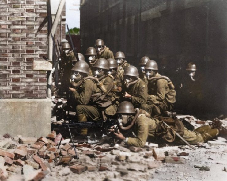 The Imperial Japanese Navy (IJN) Special Naval Landing Forces troops in gas masks prepare for an advance. Photo: Cassowary Colorizations CC BY 2.0