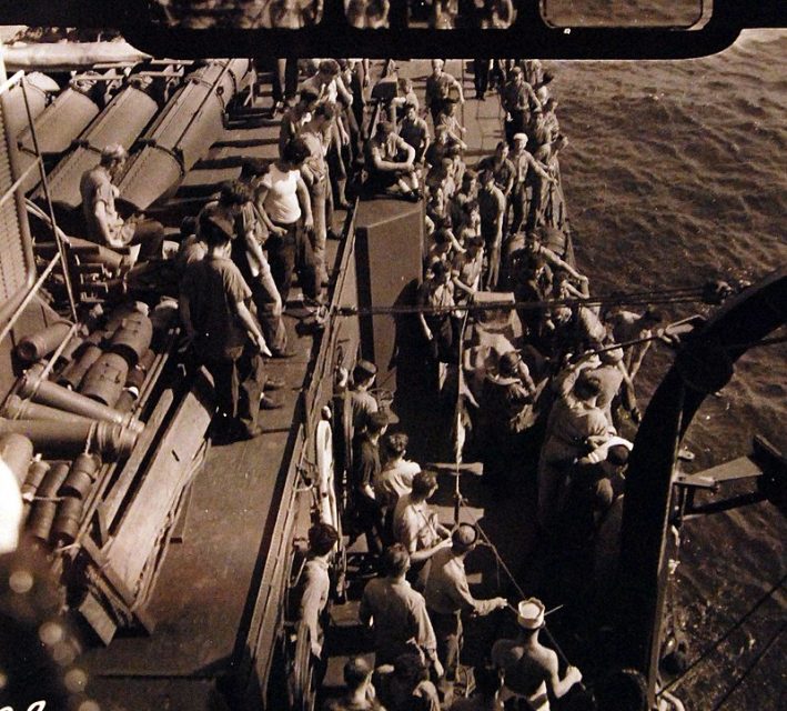 USS O’Bannon (DD 450) rescuing two pilots and two radiomen from USS St. Louis (CL 49) when in a heavy sea, just prior to the Battle of Kula Gulf, their SOC Planes were overturned in making landings.