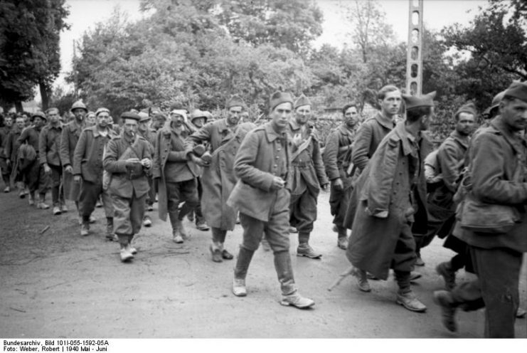 French POWs being led away from the battlefield by the German army in May 1940.