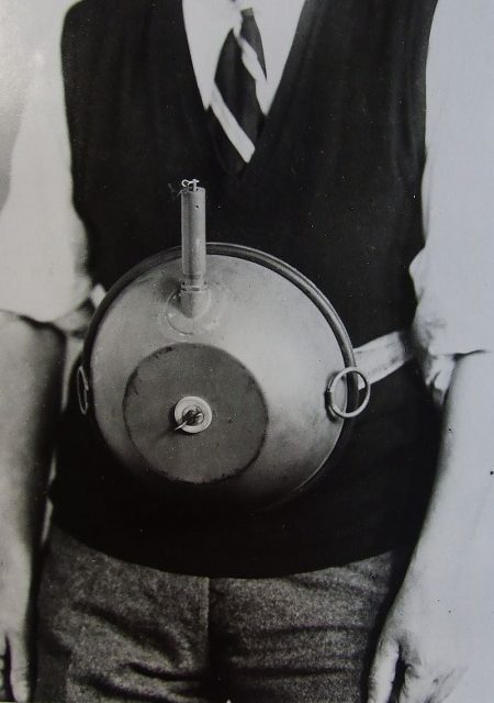 Cecil Vandepeer Clarke wearing an early version of the limpet mine on a keeper plate. It is in the position used by a swimmer although Clarke is not appropriately dressed.