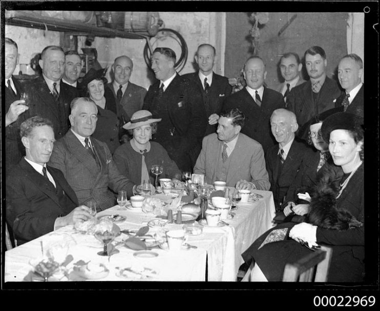 Count Felix Graf von Luckner standing in centre in profile at a dinner