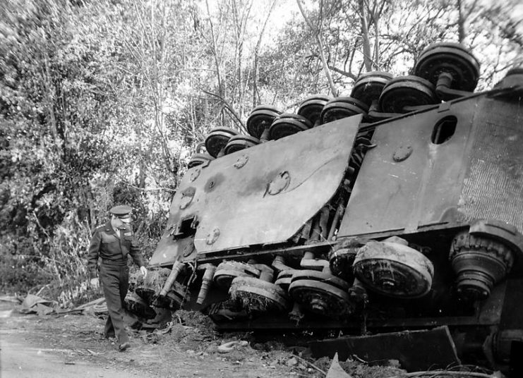Gen. Dwight D. Eisenhower, supreme commander of the Allied expeditionary forces, inspects an overturned German Tiger II tank left by a roadside in France by the retreating enemy.
