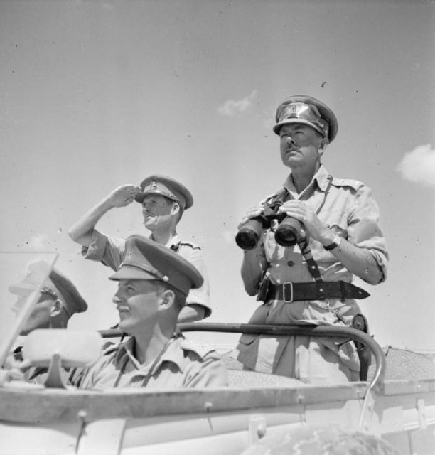 General Sir Harold Alexander, as Commander-in-Chief, Middle East, surveys the battlefront from an open car. To his right is Major General John Harding.