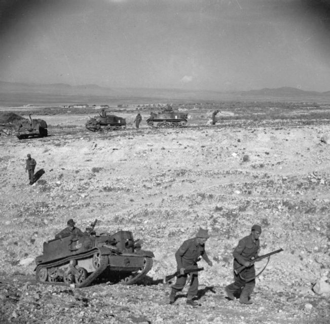 Infantry and carriers of the Grenadier Guards advance over difficult terrain near the Kasserine Pass, 24 February 1943.