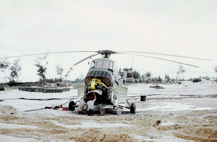 U.S. Marine Corps technicians examine the Wright R-1820 engine of a disabled Sikorsky UH-34D Seahorse helicopter at the NSAD Cua Viet supply center, near Dong Ha (South Vietnam), 1 October 1966.