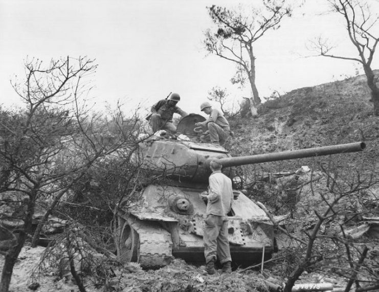US soldiers examine a T-34-85 tank captured from the Communist led North Korean forces, Waegwan, Korea.