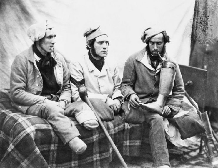 Crimean War casualties with amputated legs who were seen by HM Queen Victoria when she visited Chatham Hospital. Left to right – William Young, Henry Burland and John Connery. John Connery is holding his artificial leg.
