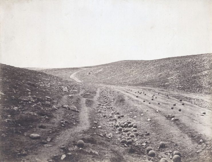 Valley of the Shadow of Death – Dirt road in ravine scattered with cannonballs, by Roger Fenton, one of the most famous pictures of the Crimean War