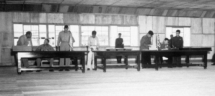 UN delegate Lieut. Gen. William K. Harrison, Jr. (seated left), and Korean People’s Army and Chinese People’s Volunteers delegate Gen. Nam Il (seated right) signing the Korean War armistice agreement at P’anmunjŏm, Korea, July 27, 1953.