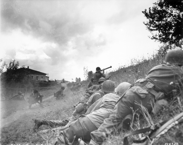 US Infantrymen advance three miles north of Lucca (furthermost point occupied by US troops) to contact an enemy machine gun nest. A bazooka-man cuts loose at the target some 300 yards distant