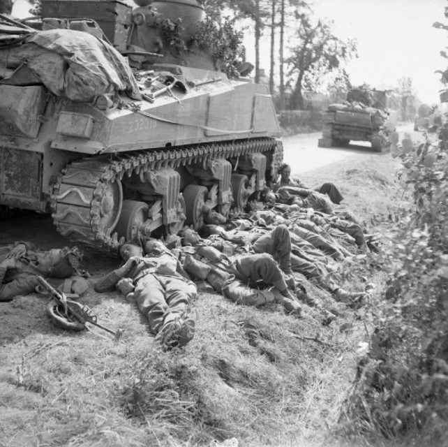 3rd Royal Tank Regiment by a Sherman tank during a break