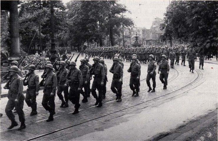 U.S. Soldiers march in a victory parade in Dusseldorf, Germany, on V-E Day, May 8, 1945.