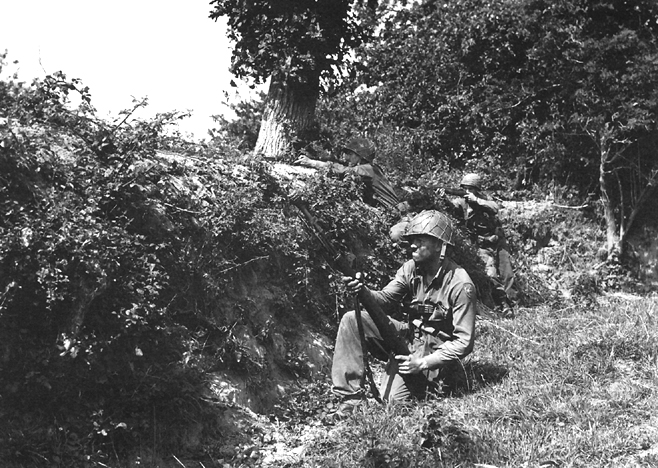 American soldiers near a hedgerow in Normandy, 1944.