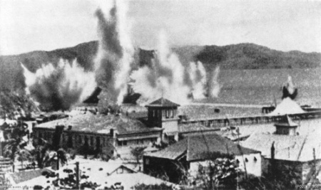 Bombs explode in Port Moresby’s harbour during one of the first Japanese air raids on the town in 1942