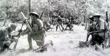 Malayan infantry operating their 3 inch mortars.