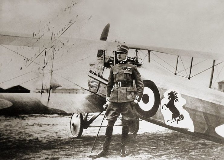 Count Francesco Baracca, standing by his SPAD XIII fighter with the prancing horse logo that later became the emblem of Ferrari