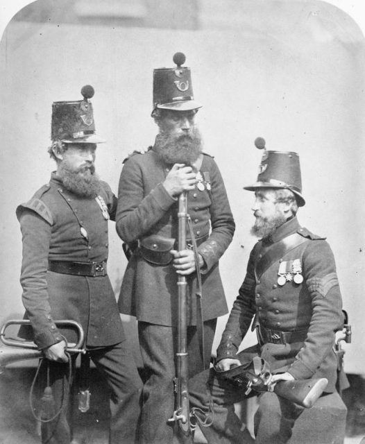 Trumpeter Robin, Private Hill and Corporal Wiseman, of the Rifle Brigade with equipment.