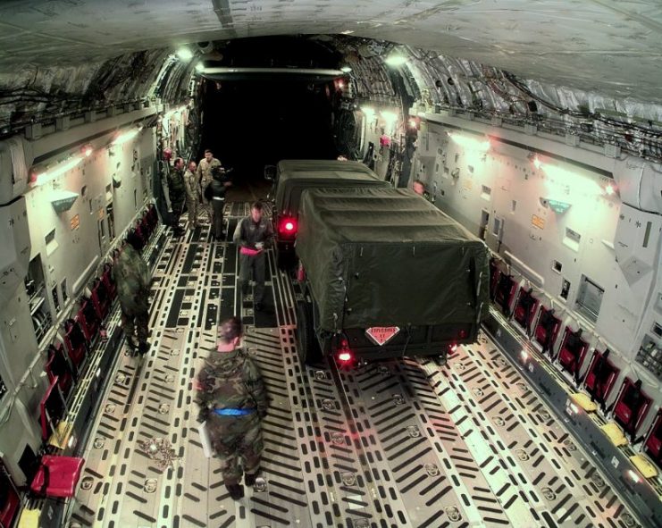 A 437th Civil Engineer Squadron explosive ordnance disposal team Humvee and trailer are backed into a C-17A Globemaster III at Charleston Air Force Base, S.C.