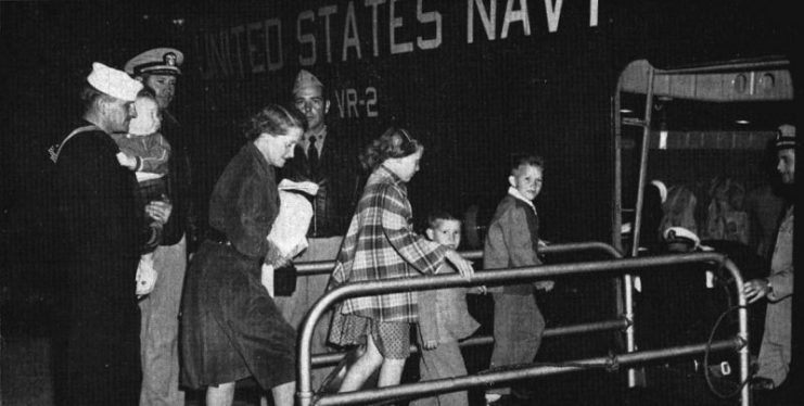Passengers are greeted by U.S. Navy Captain W.A. Sullivan before boarding a Martin JRM Mars at Naval Air Station Alameda, California (USA), for a flight to Pearl Harbor, Territory of Hawaii.