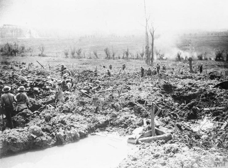 Sappers digging a communication trench towards the Messines Ridge. Shells bursting in the distance. June 7, 1917.