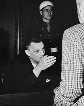 Seyss-Inquart (seated) talking to Wilhelm Frick at the Nuremberg trials.