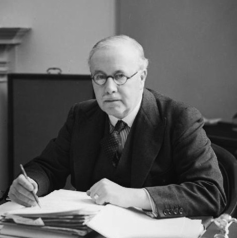 Sir Kingsley Wood, the Secretary of State for Air from September 1939 to April 1940, seated at his desk at the Air Ministry.