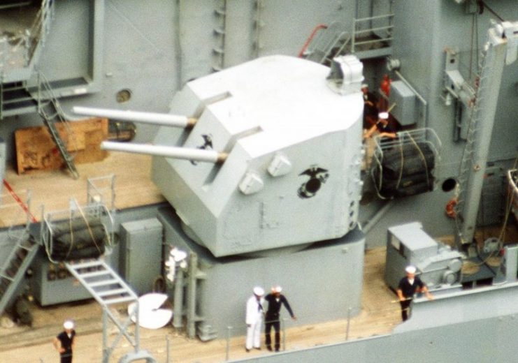 A 5-inch gun mount emblazoned with the Eagle, Globe, and Anchor of the United States Marine Corps aboard the battleship New Jersey.