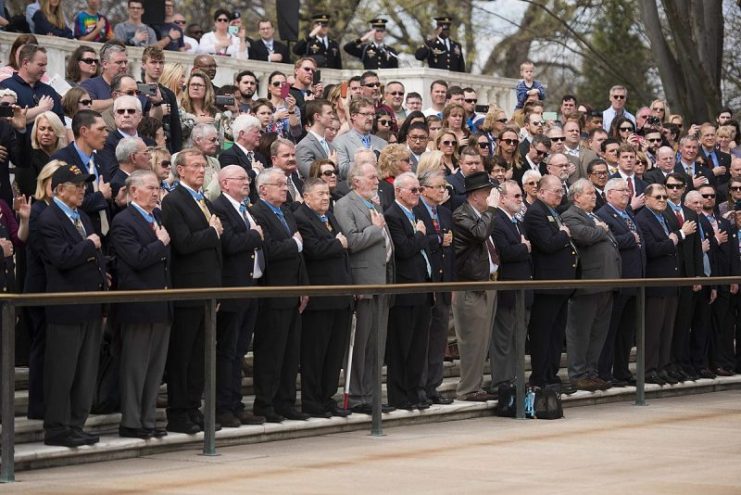 Medal of Honor recipients, and other visitors, watch an Army full honors wreath laying ceremony at the Tomb of the Unknown Soldier in Arlington National Cemetery, March 25, 2016, Arlington, Va. The wreath laying for Medal of Honor Day