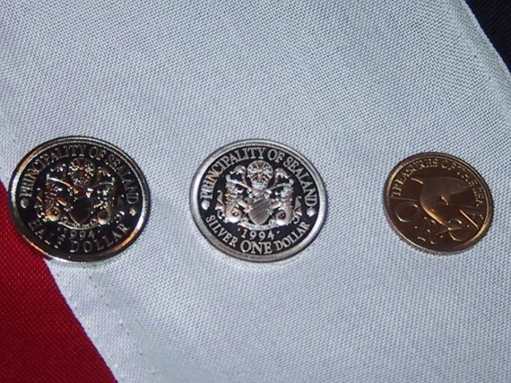 Sealandic coins, from left to right: half dollar, silver one dollar and quarter dollar