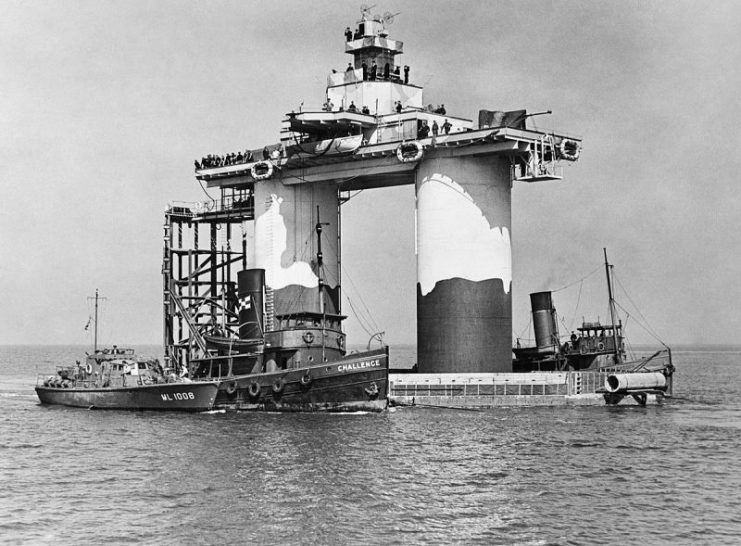The completed fort with its steel superstructure, guns and personnel is towed to sea