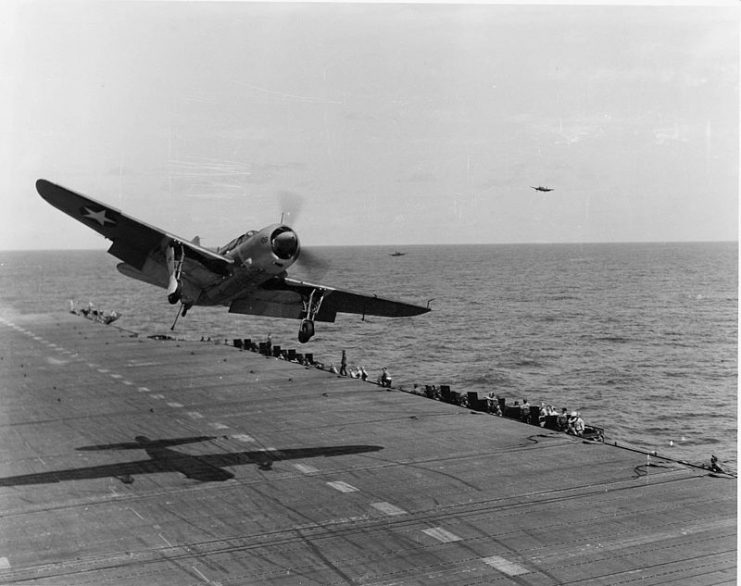 A U.S. Navy Curtiss SB2C-1 Helldiver of Bombing Squadron 17 (VB-17) takes a wave-off during flight operations aboard the aircraft carrier USS Bunker Hill (CV-17) in the Caribbean, in 1943.