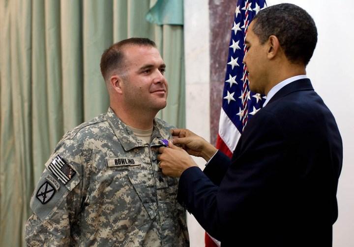 Soldier being awarded the Purple Heart, pinned with the medal by President Barack Obama.