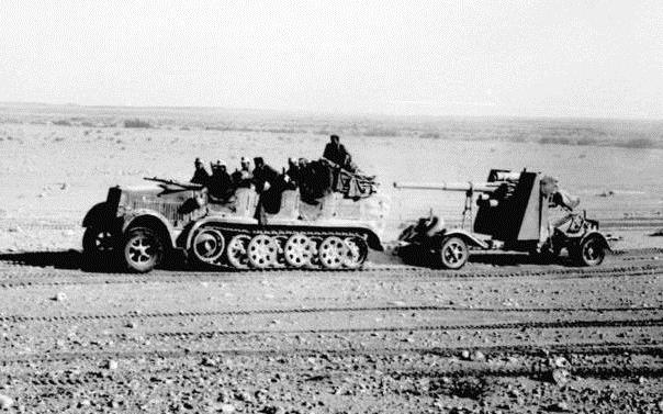 North Africa, towed behind a SdKfz 7, with its side outriggers lifted for transport visible behind the gun shield.Photo: Bundesarchiv Bild 101I-783-0109-19 CC BY-SA 3.0