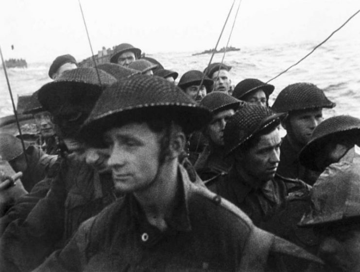 Film still from the D-Day landings showing commandos aboard a landing craft on their approach to Sword, 6 June 1944.