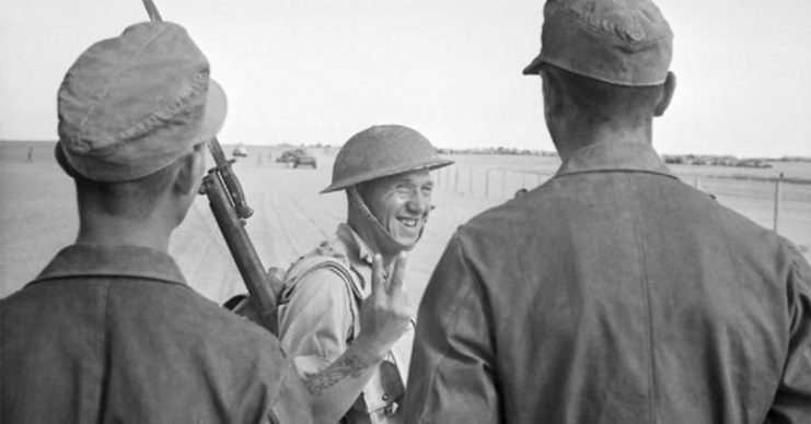 British soldier gives a V-for-Victory sign to German prisoners captured at El Alamein.
