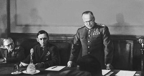 Marshal Georgy Zhukov reading the German capitulation in Berlin. Seated on his right is Air Chief Marshal Sir Arthur Tedder.