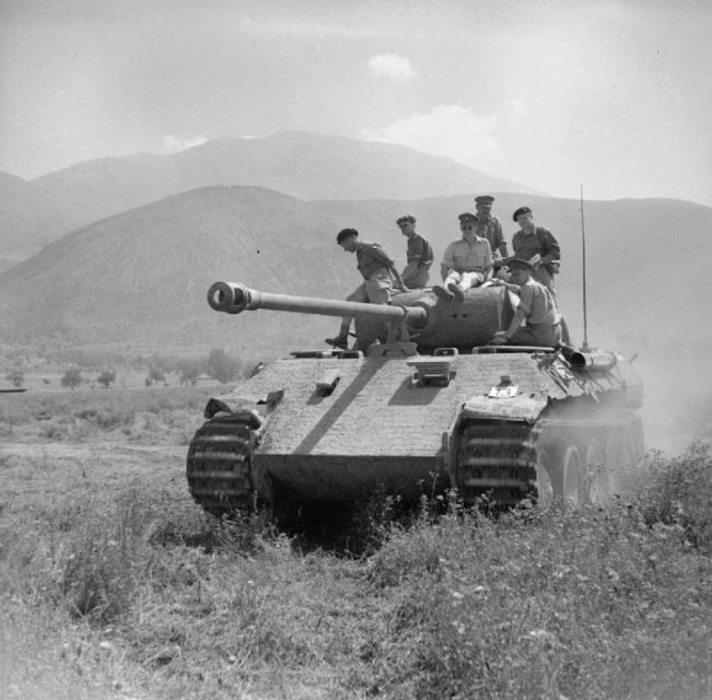 British officers ride on a captured Panther tank in Italy, June 1944, with an early “letterbox” hull gun aperture