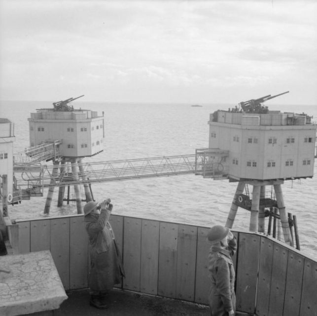 Anti-aircraft crews scan the sky from a Maunsell sea fort in the Thames Estuary, 19 November 1943.