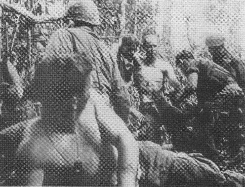 U.S. wounded being moved to an aid station during the battle for Hill 882.