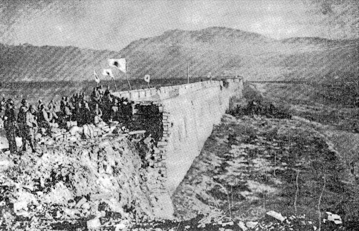 Japanese soldiers stand atop the ruins of Nanking’s Zhongshan Gate on December 13 with Zijinshan in the background.