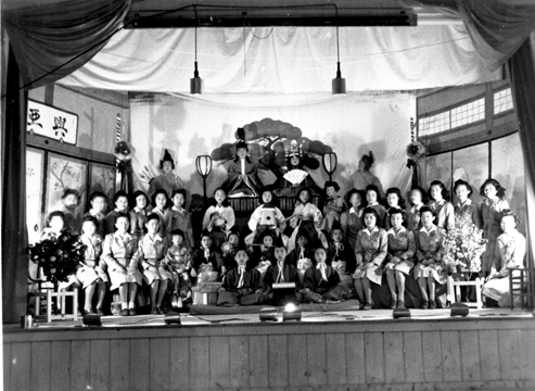 Actors and others at Girl Scout dramatic presentation at Hinamatsuri (Doll’s Festival) on Japanese Girl’s Day on stage at Crystal City Internment Camp, Crystal City, Texas, 1943-45.
