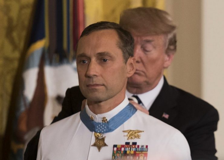 President Donald J. Trump presents the Medal of Honor to retired Master Chief Special Warfare Operator (SEAL) Britt Slabinski during a ceremony at the White House in Washington, D.C. Slabinski received the Medal of Honor for his actions during Operation Anaconda in Afghanistan in March 2002.