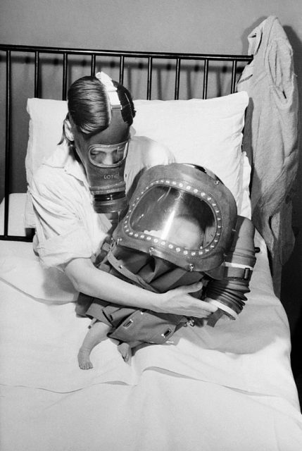 A mother and baby both in gas-masks during 1941