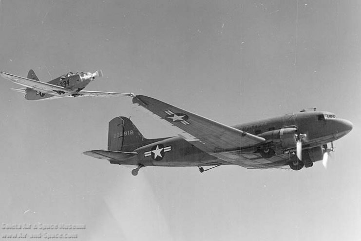 The photo above shows history’s first in-air coupling of two separately flying aircraft and subsequently, the switch-off of the smaller aircraft’s engine.