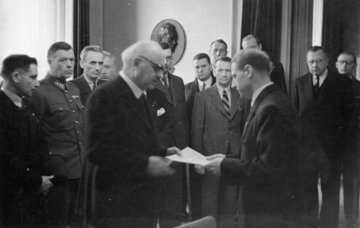 Conti being presented with a report on the Katyn massacre discovered by the Germans in 1943