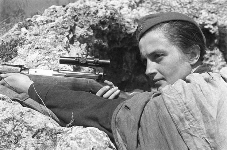 Female sniper Lyudmila Pavlochenko with her rifle in a trench.