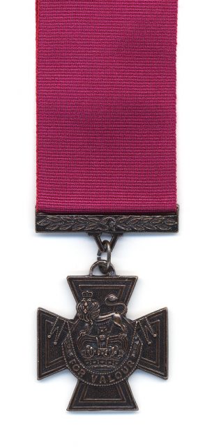 A British Victoria Cross with a crimson ribbon. Medals