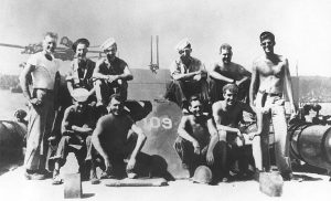 Lieutenant (junior grade) Kennedy (standing at right) with his PT-109 crew, 1943.